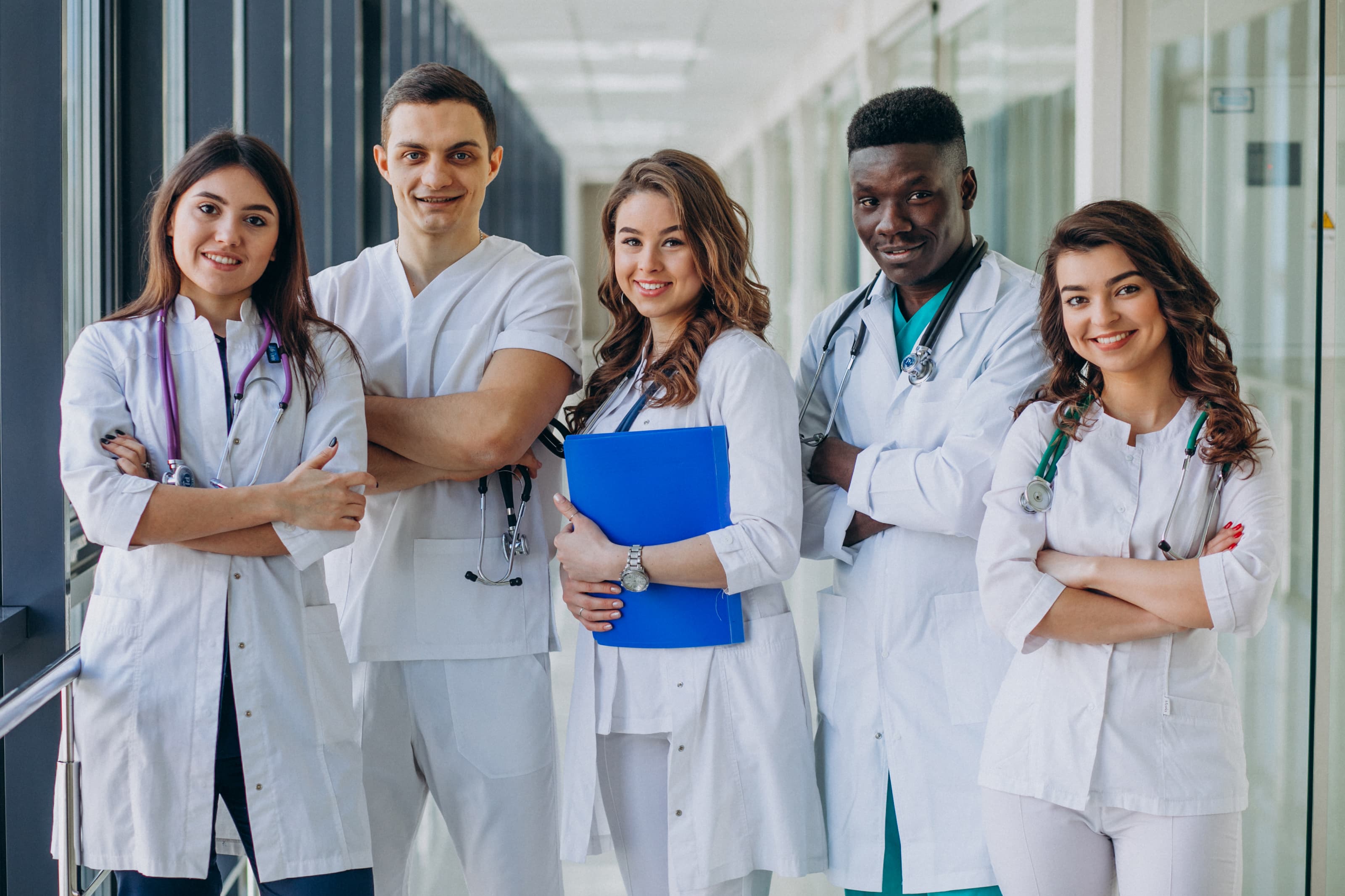 A small team of physicians standing together in a hospital corridor.